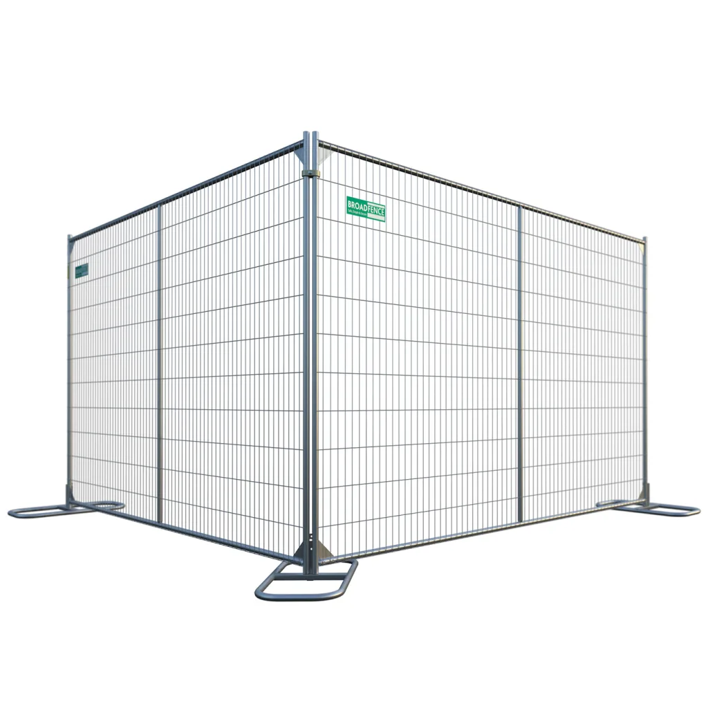 Temporary metal construction fence panel with supporting bases and a small green Broadfence sign on the mesh panel
